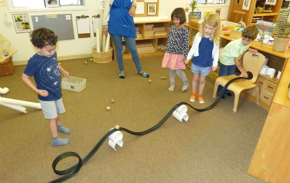 preschoolers making car tracks